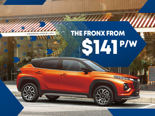 An orange Suzuki Fronx SUV with blue arrows surrounding with white text